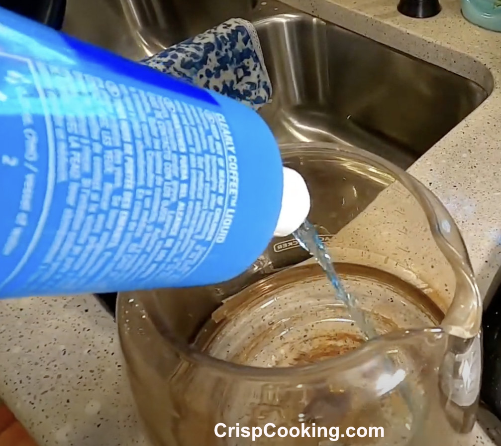 Applying Liquid Cleaner to Coffee Pot