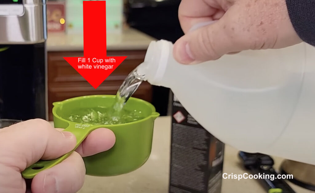 Fill one cup with white vinegar