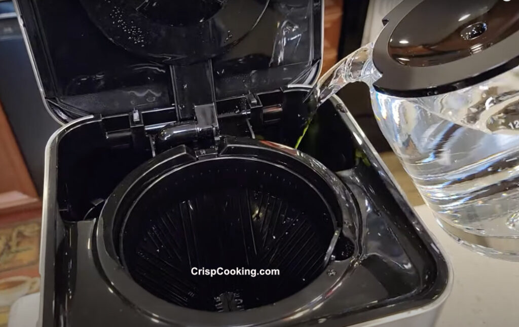 Pour water with vinegar where water goes on braun coffee maker