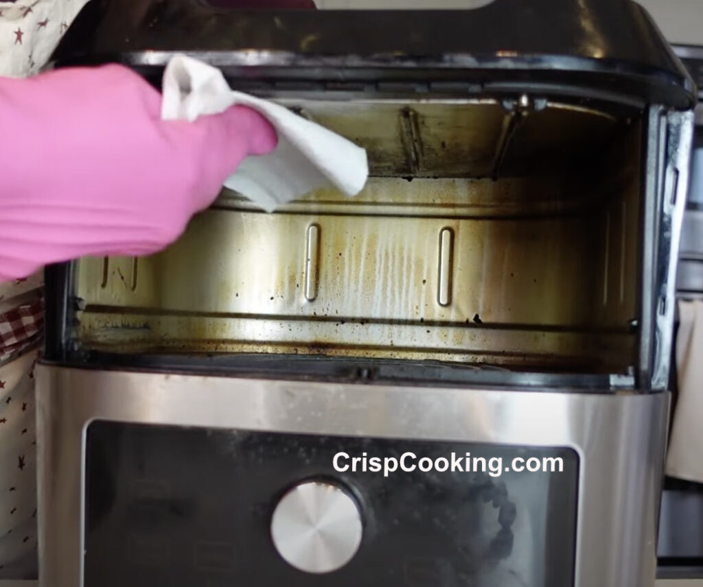 Clean inside Instant Vortex air fryer with paper towel