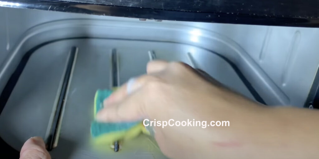 Clean inside floor of cosori air fryer with sponge