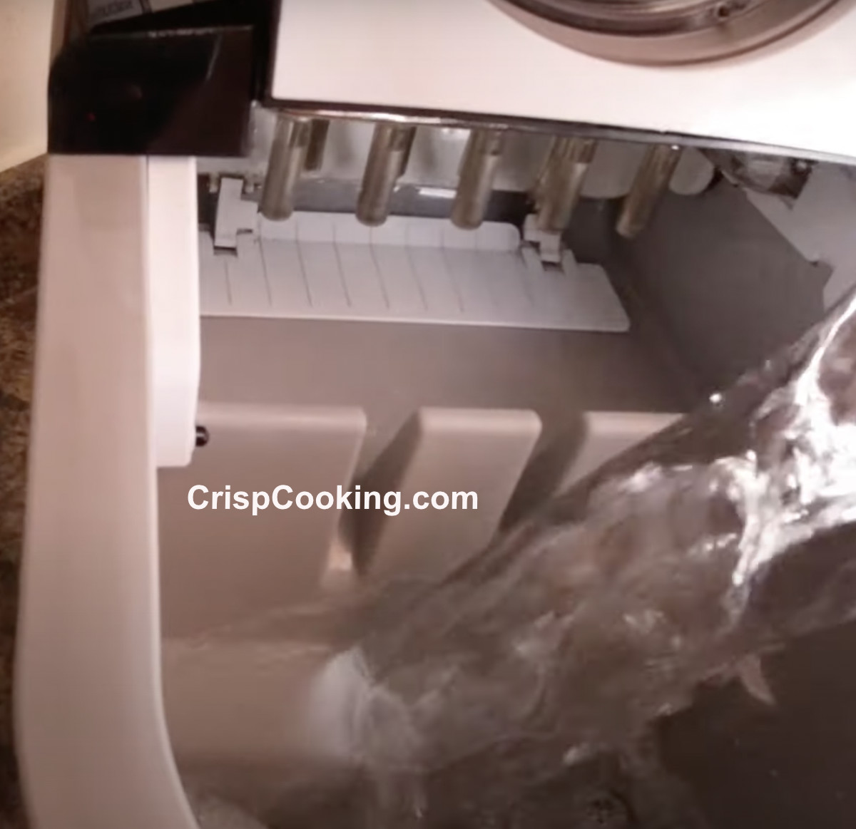 Pour cleaning solution to Frigidaire ice maker